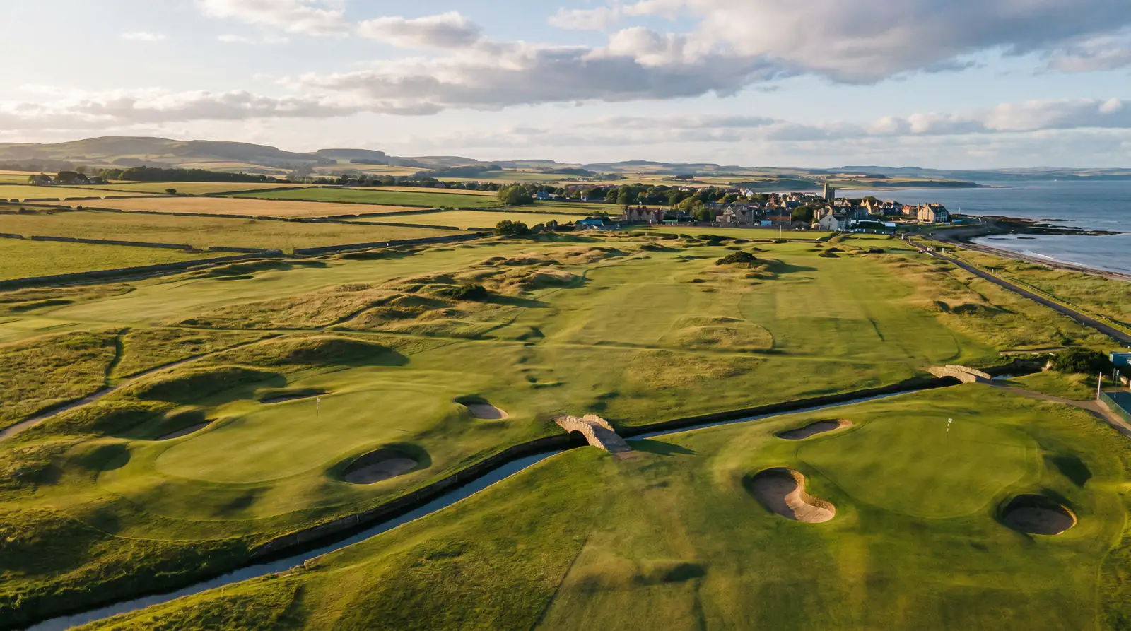 Aerial view of a well-known European golf course showing distinctive hole layouts and surrounding countryside