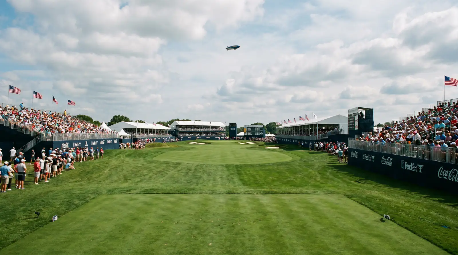 Wide fairway at a PGA Championship venue with grandstands and spectators visible along the treeline